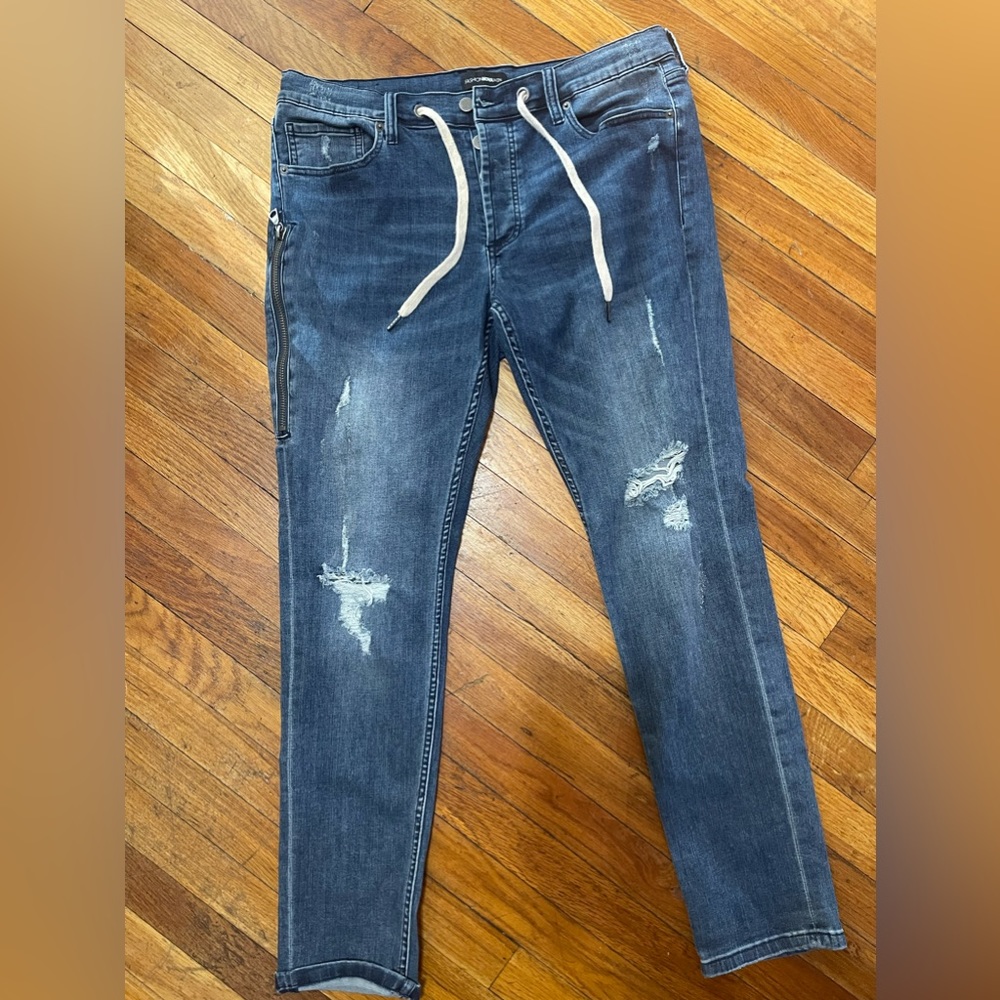 Men’s FashionNova Blue distressed with leg pocket. NWOT